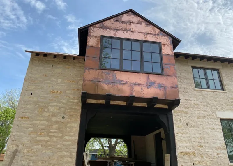 Copper metal panel facade on a stone building for Metal Roof Coating in Liberty