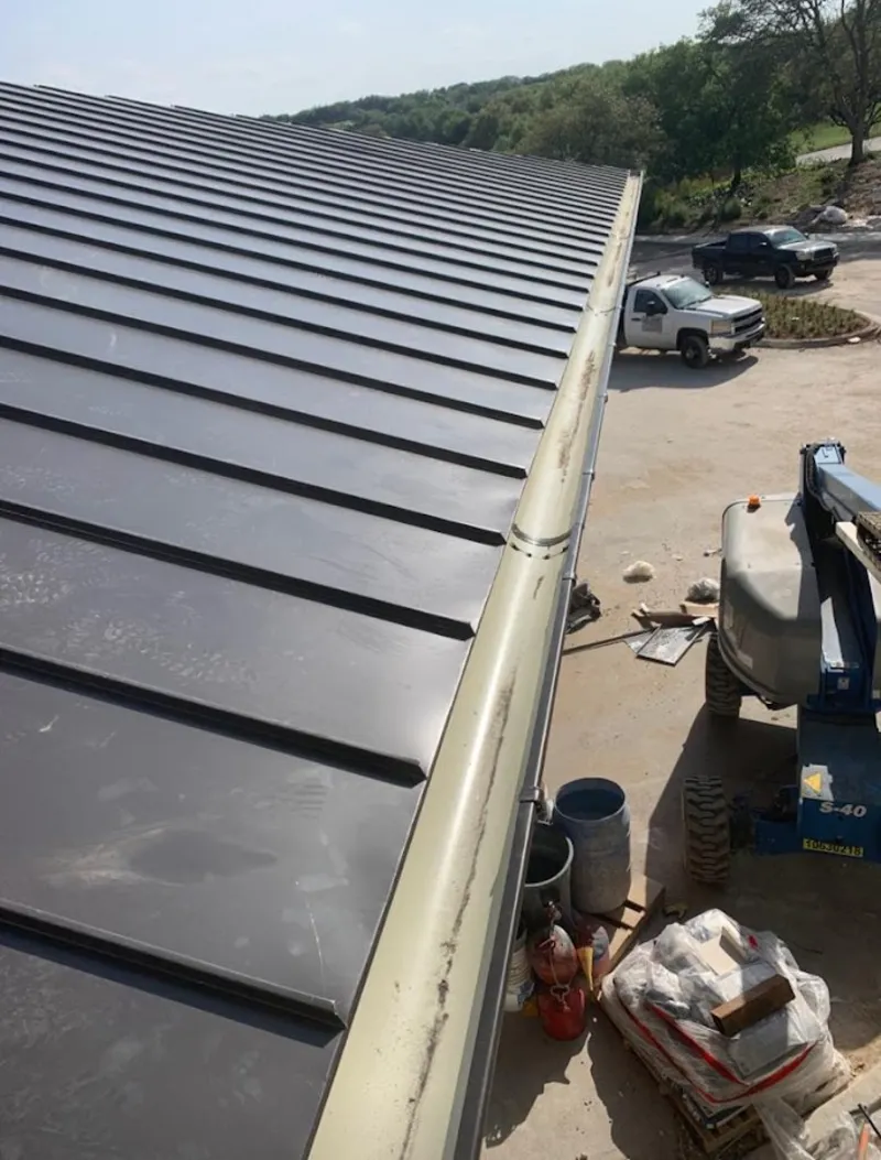 Standing seam panel and gutter detail on a metal roofing jobsite in Liberty